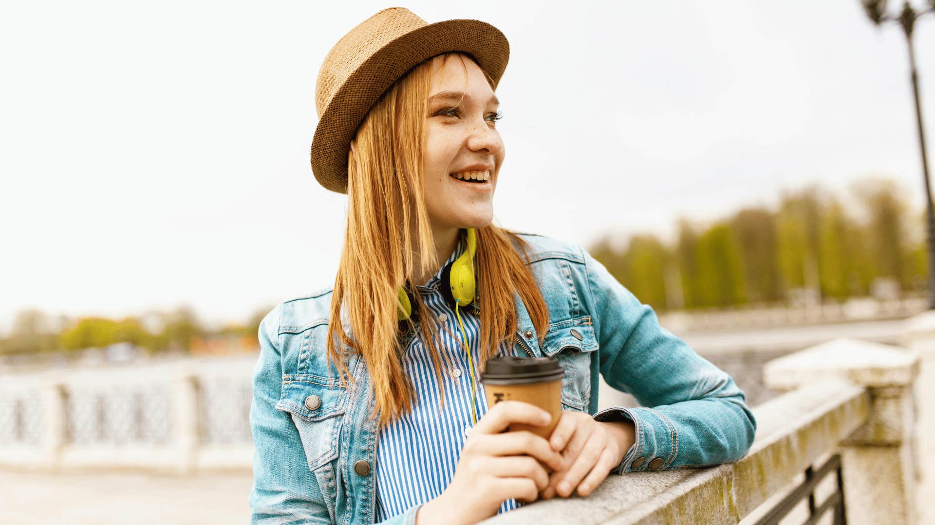 woman leaning against rail and smiling 