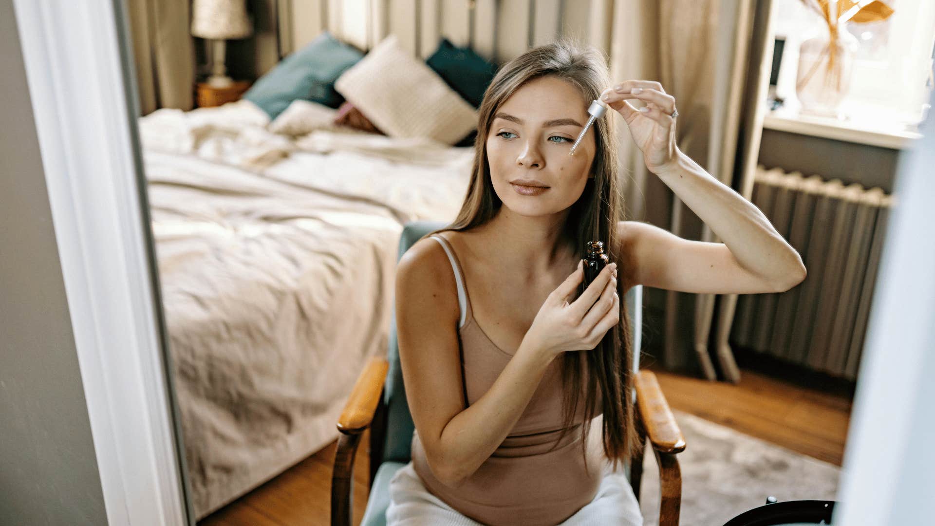 woman doing self-care in front of mirror