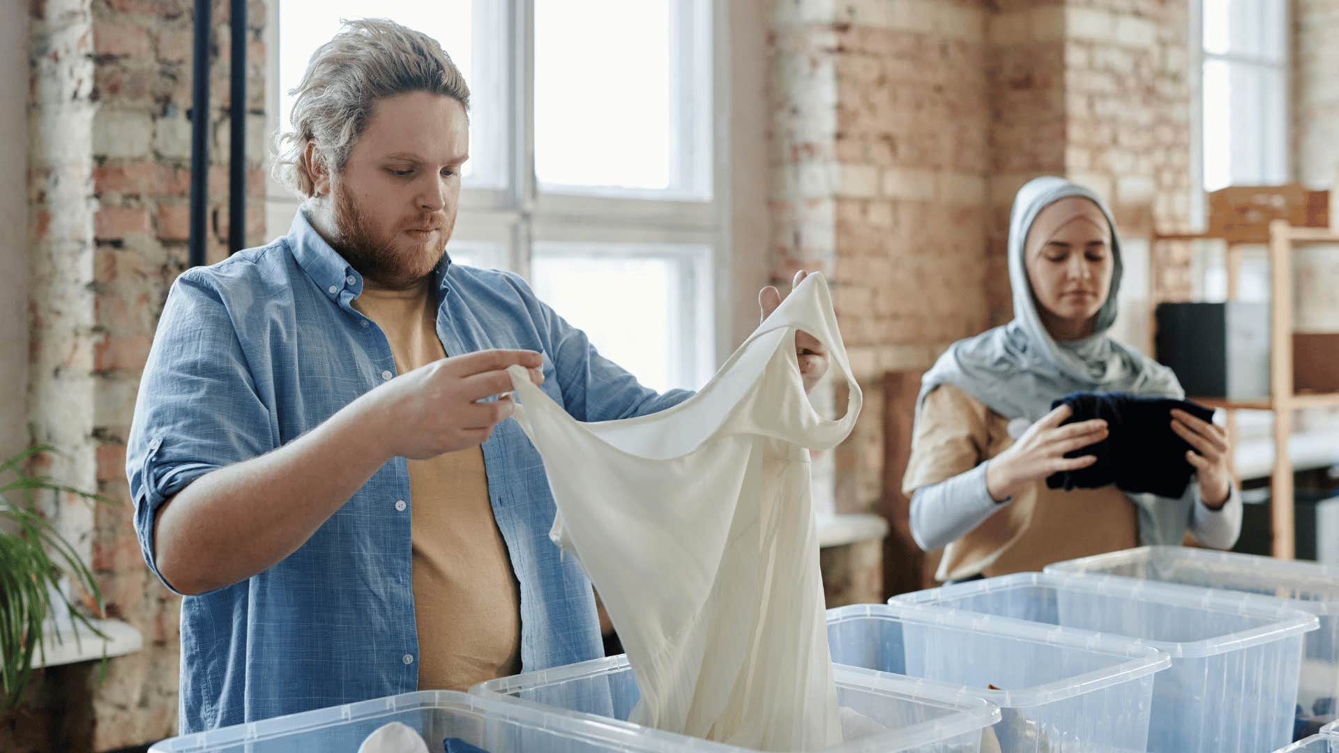 man helping to organize donations 