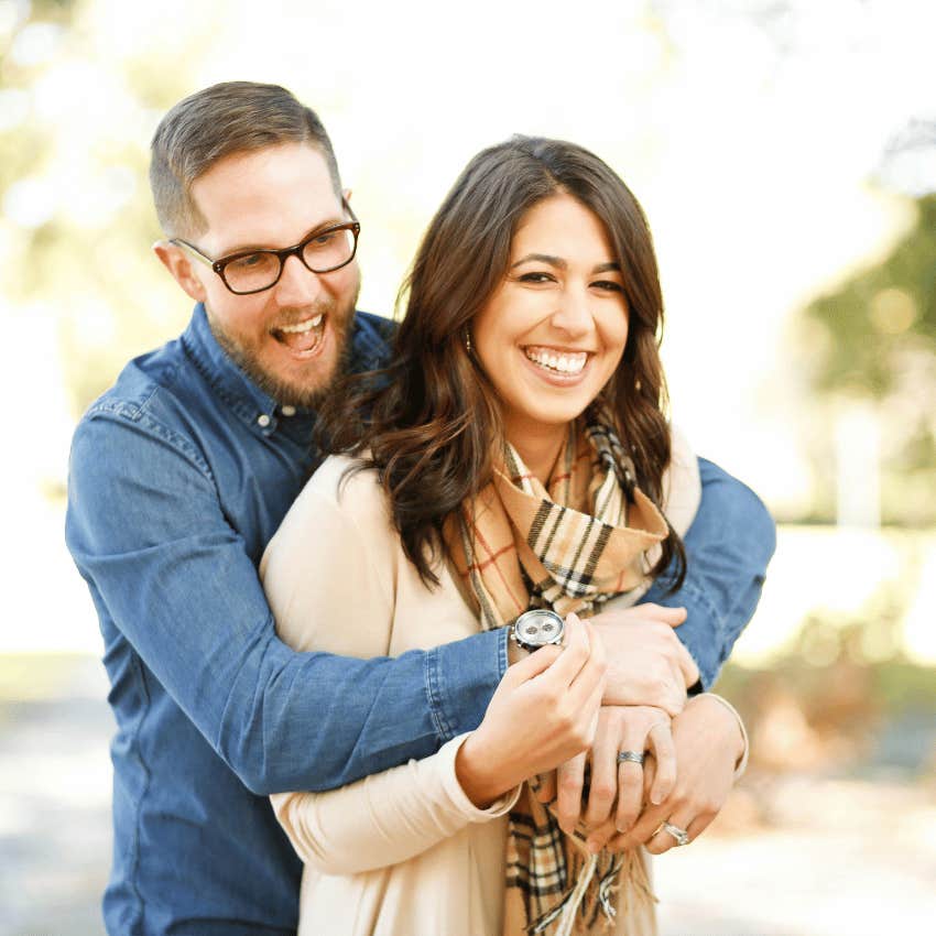 happy couple in healthy relationship hugging