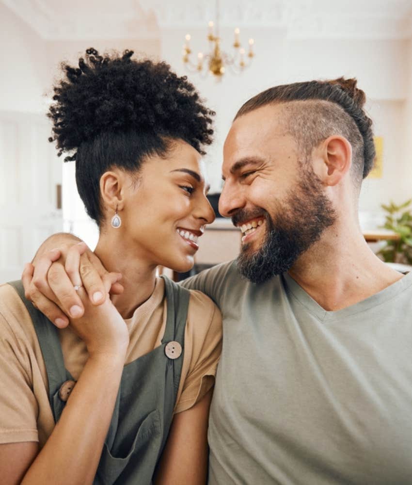 happy young couple smiling at each other