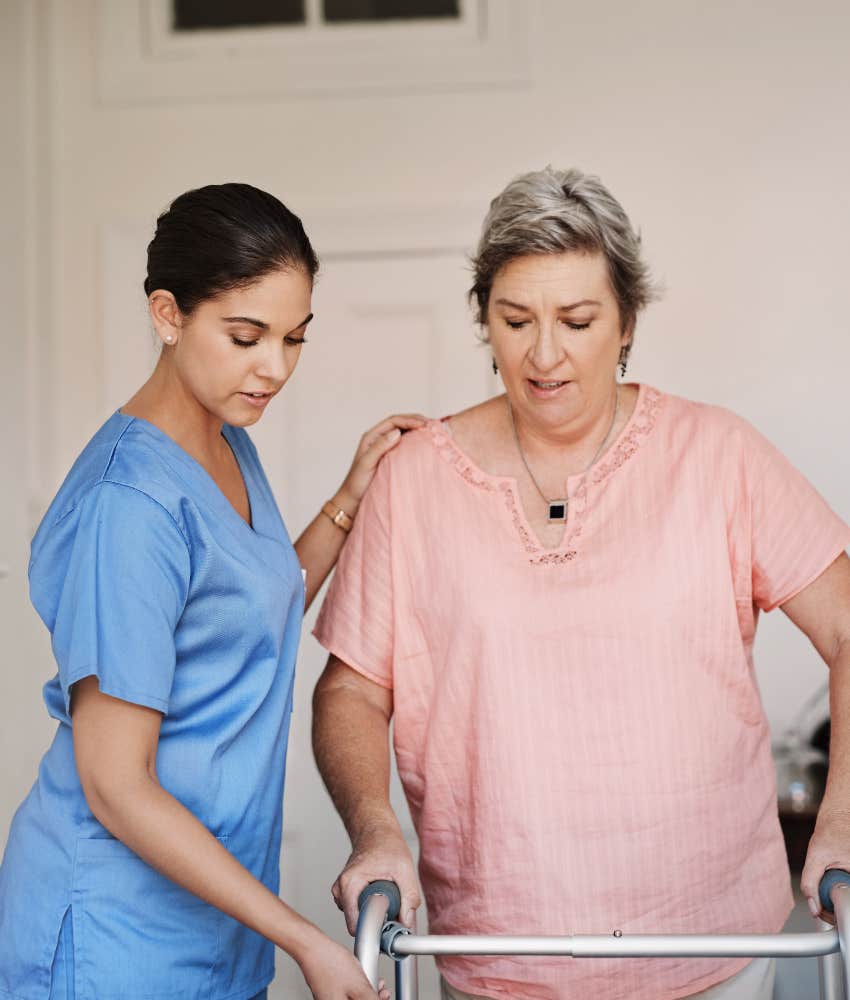 female healthcare worker helping patient with walker