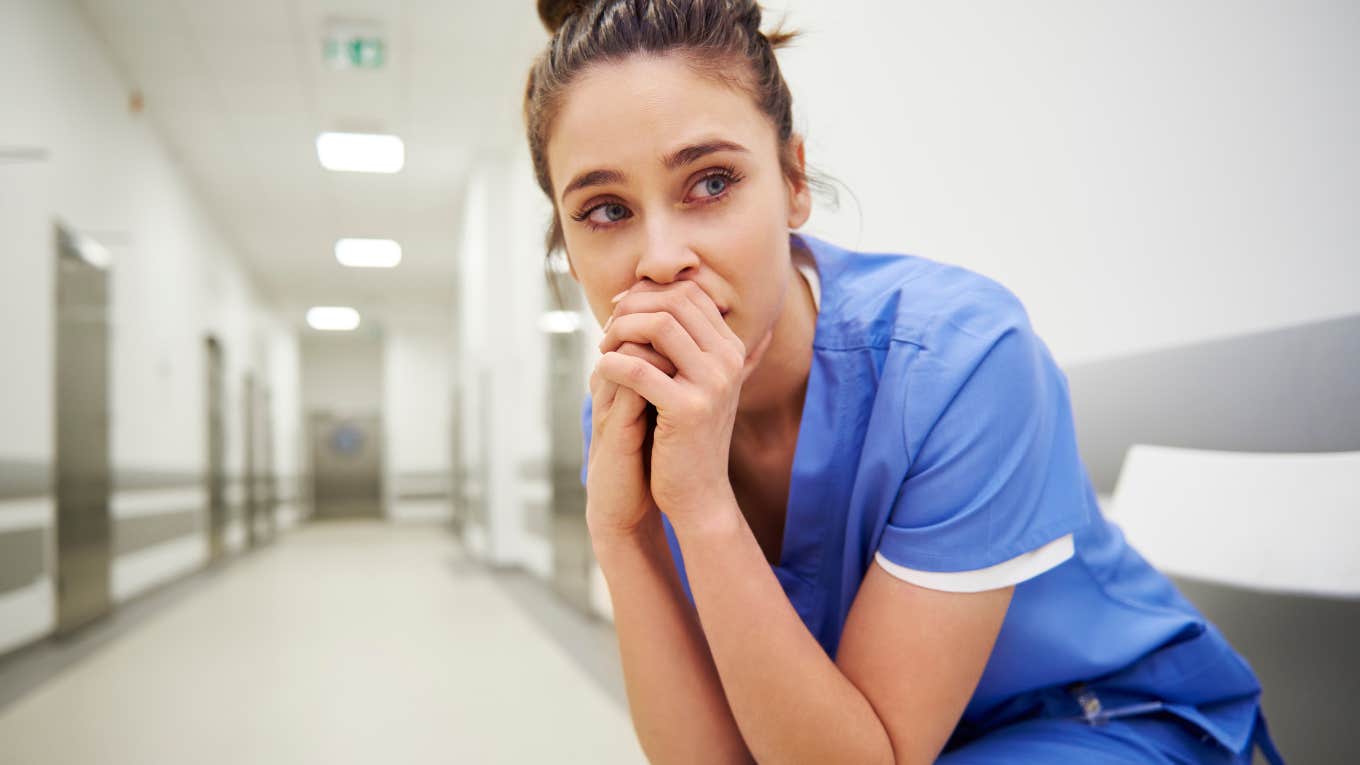 stressed out healthcare worker in scrubs