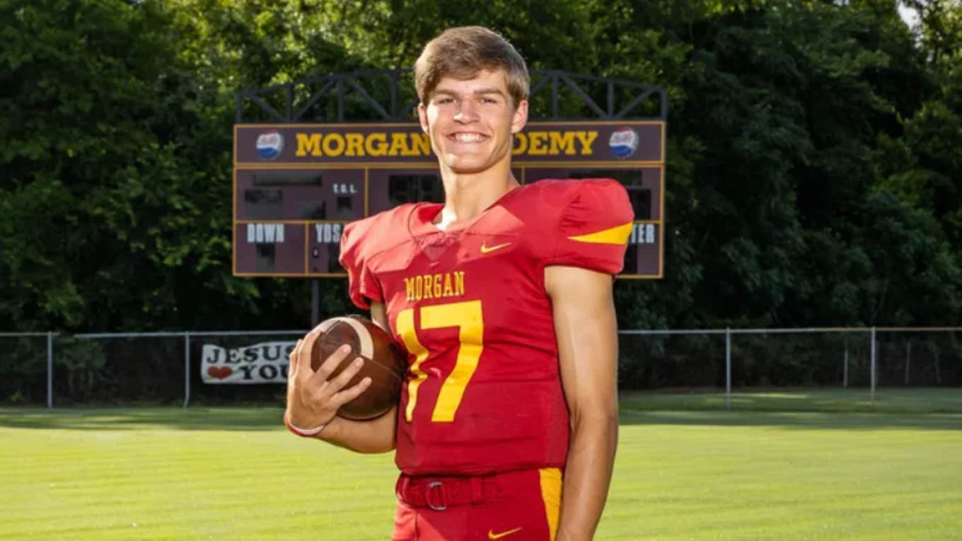 Caden Tellier holding a football on the field