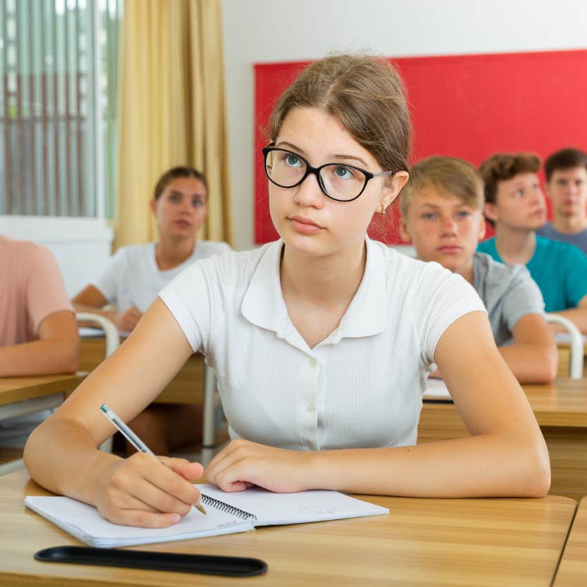 High school student working in classroom. 