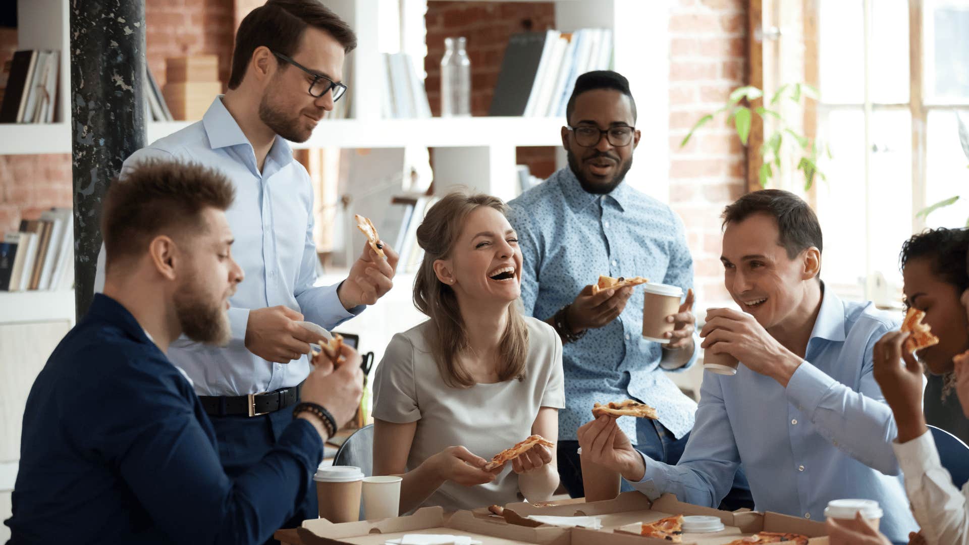 woman laughing and joking with coworkers at job 