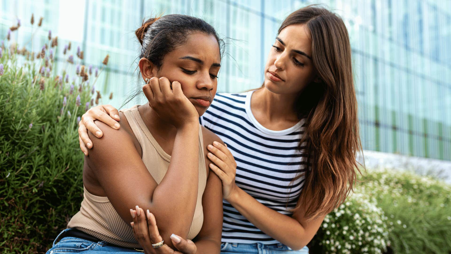 woman comforting other woman