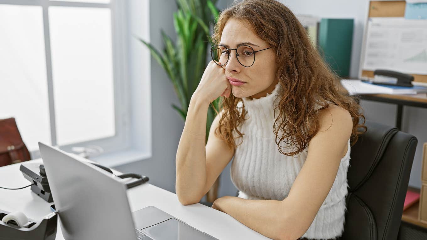 Woman looking upset reviewing her paycheck online. 