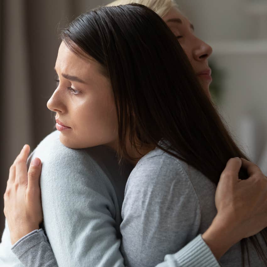 Woman hugging overwhelmed loved one