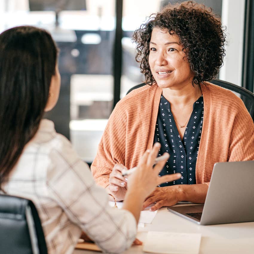 Employees in an office talking about promotions.