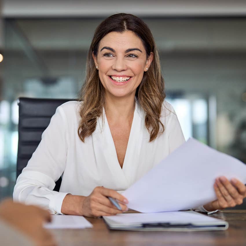 Interviewer smiling during a conversation.