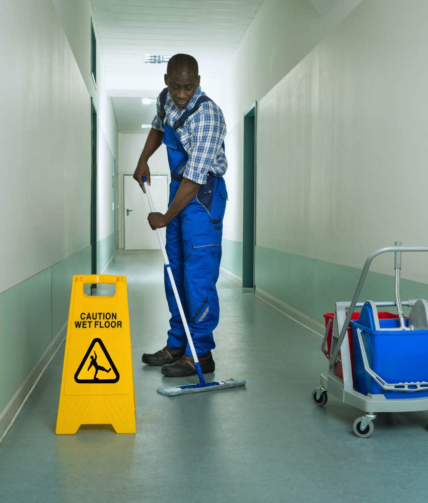 Janitor mops hallway