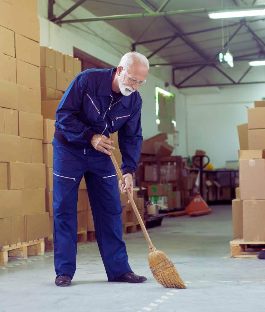 janitor sweeping in a warehouse