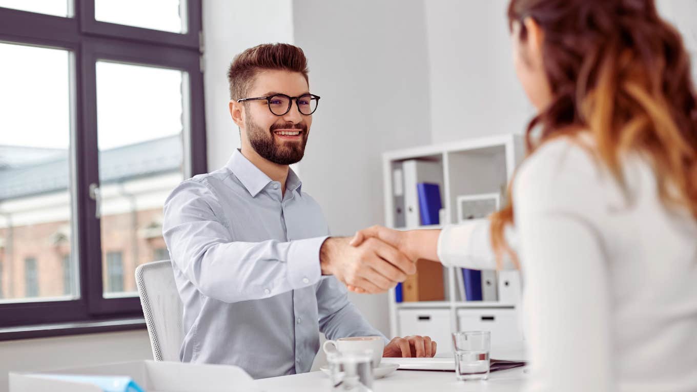 job applicant shaking hiring managers hand during interview