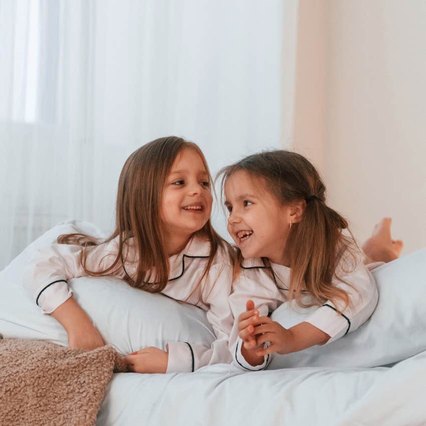 Kids share a room and lay in the bed.