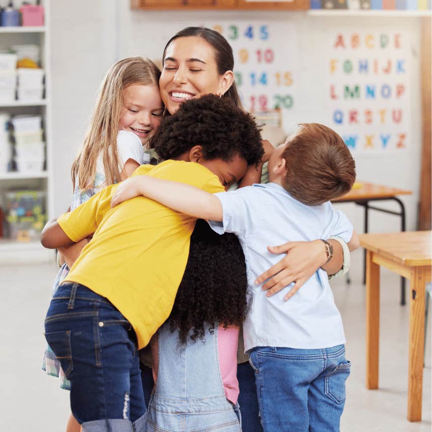 teacher getting hugged by kids