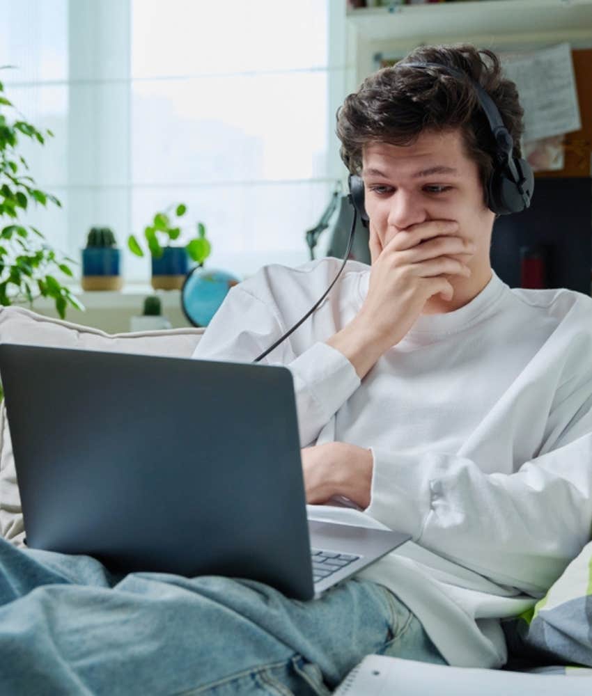 teen with headphones looking at laptop