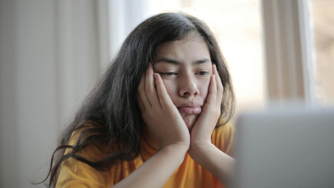 Lazy daughter staring at laptop