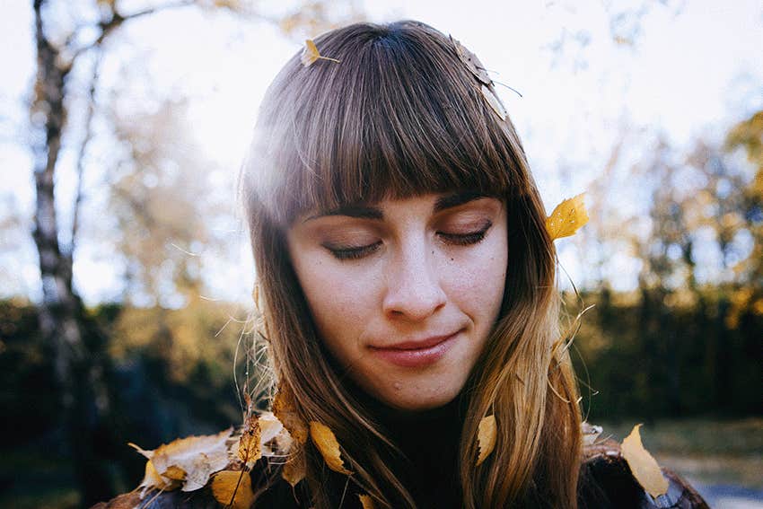 beautiful woman dressed boho style sitting on the autumn