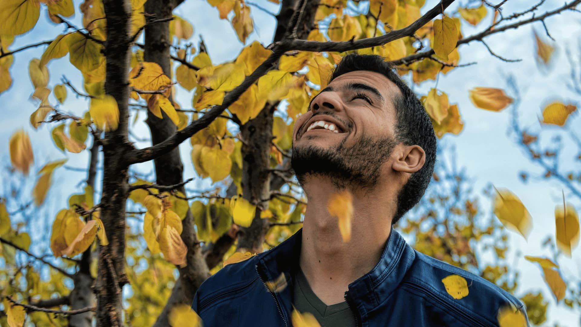 man smiling and looking up at sky