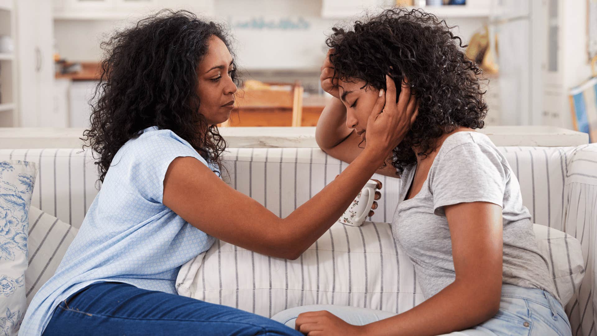 mother comforting teenage daughter