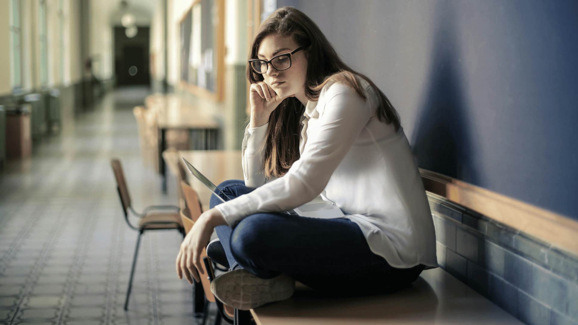 young woman alone in hallway