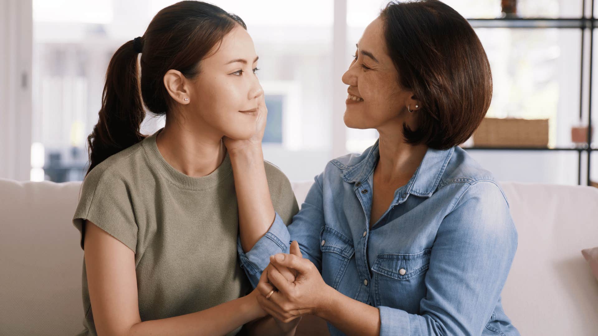 mother holding daughter's face