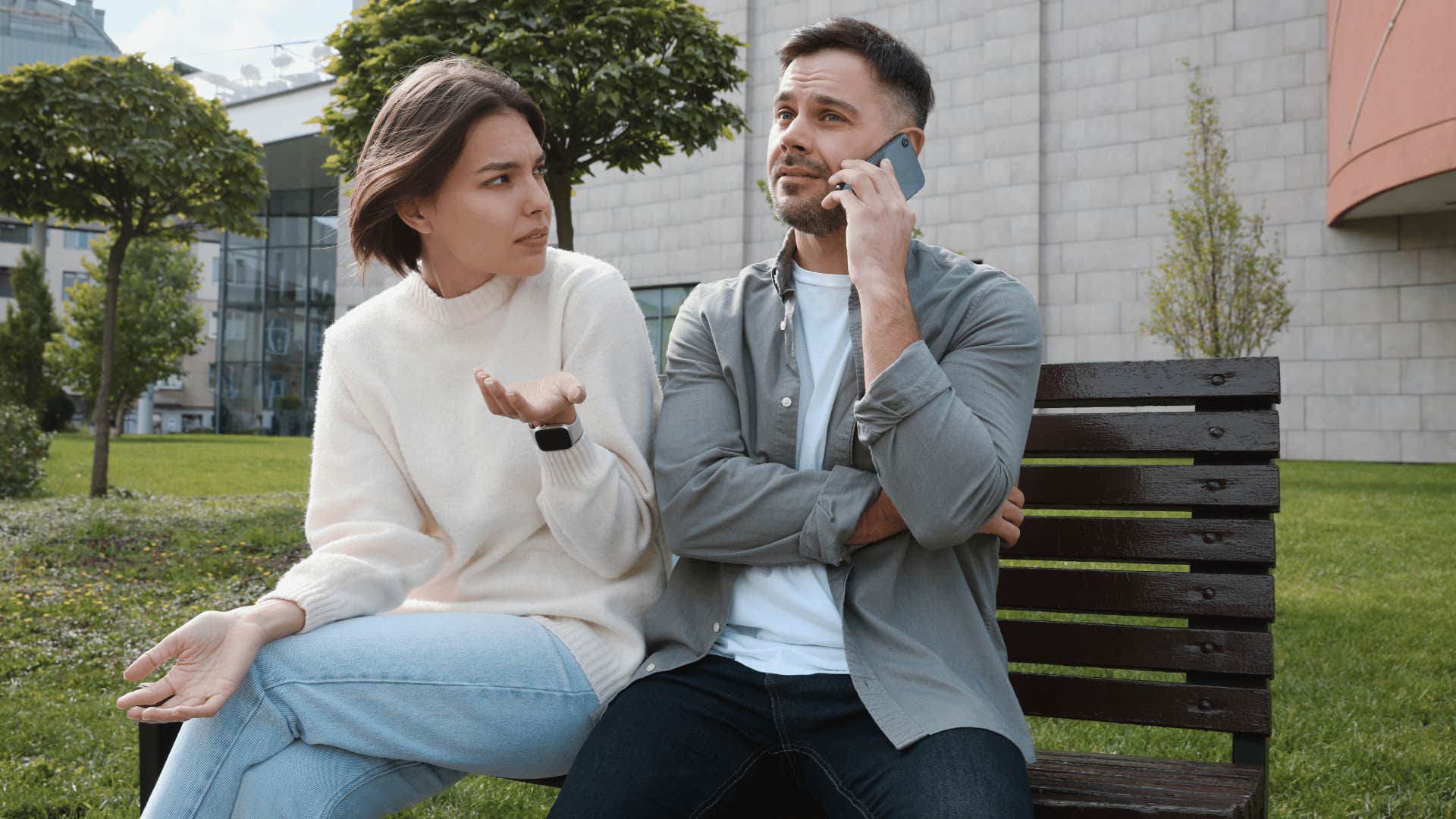 woman arguing with man while he's on phone