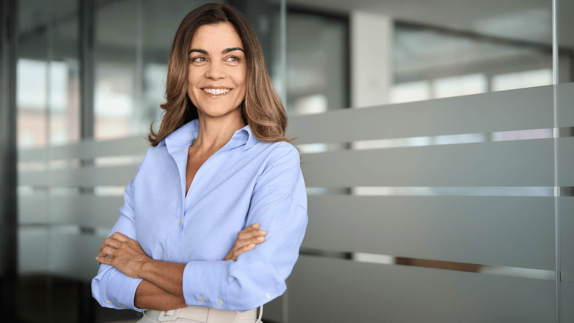 woman crossing arms while smiling