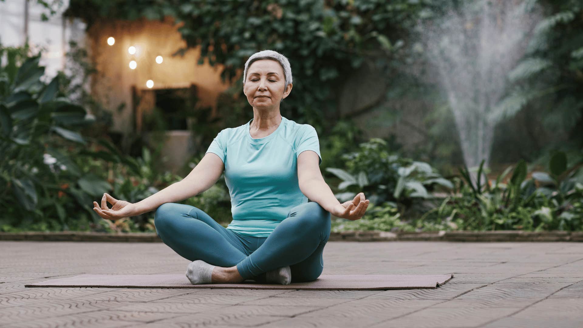 woman meditating on yoga mat