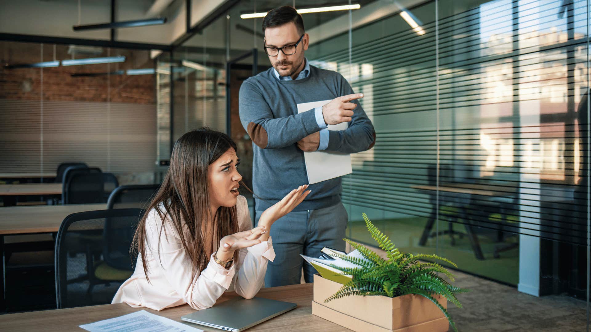 woman looking upset while man tells her to leave