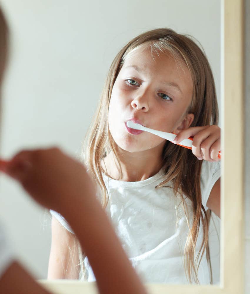 little girl brushing her teeth