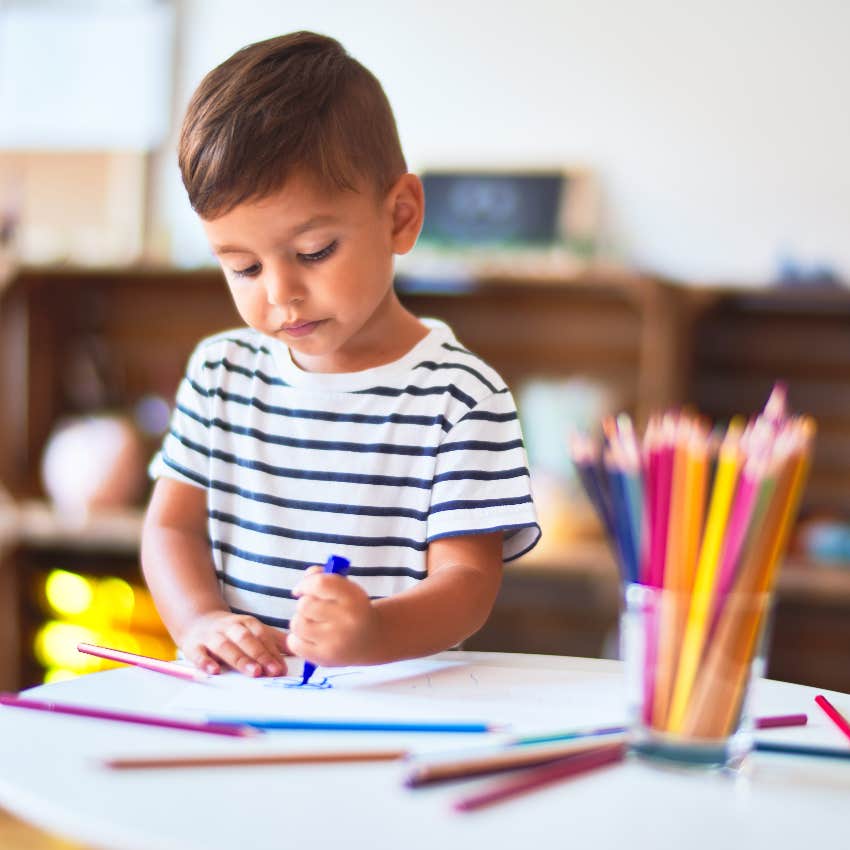 toddler coloring a concerning art project assigned at preschool