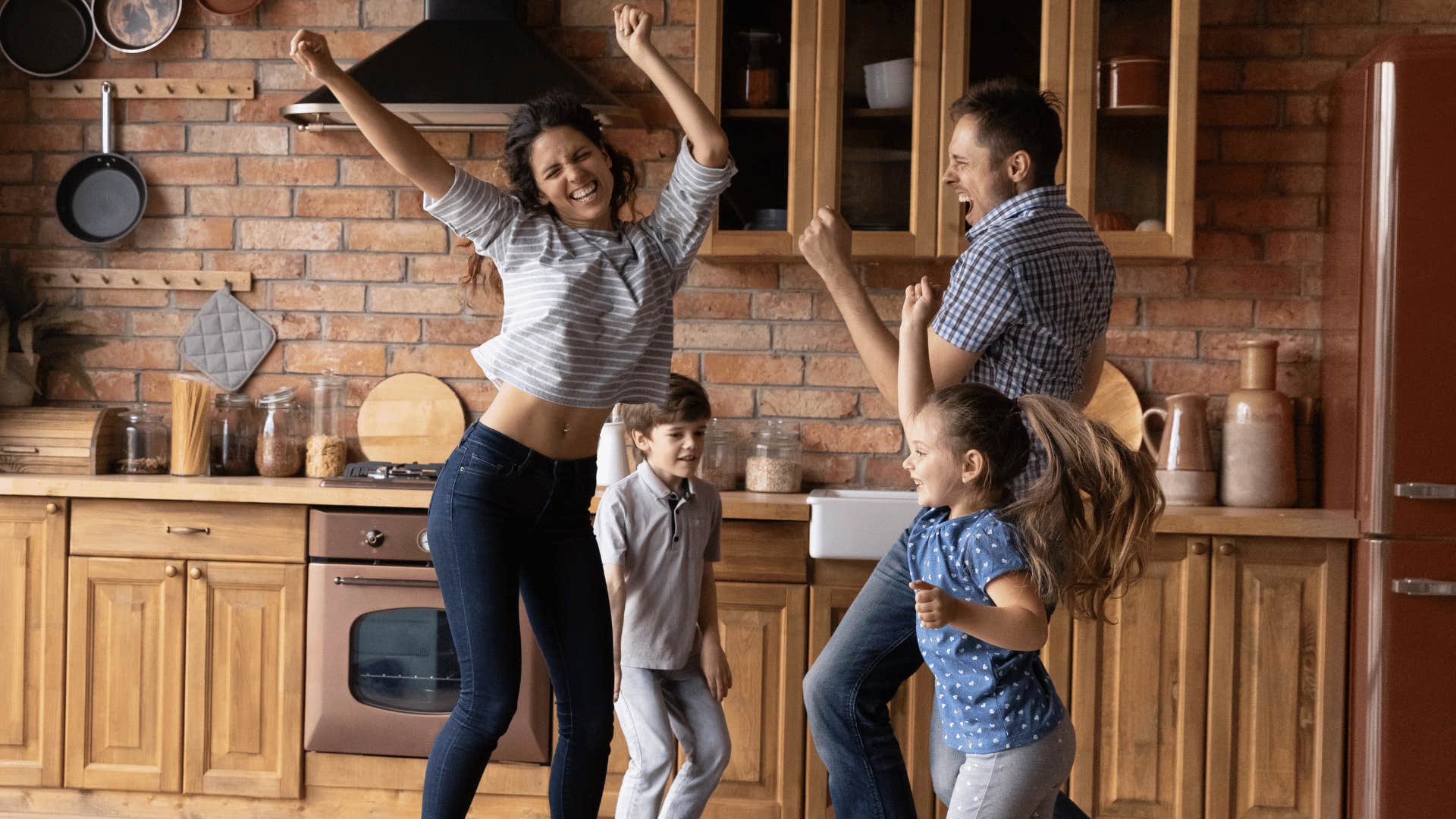 family dancing in kitchen