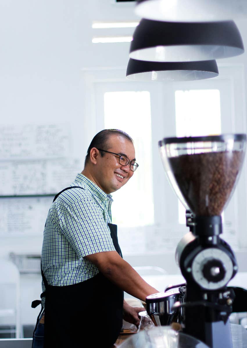 male barista behind the counter at a coffee shop