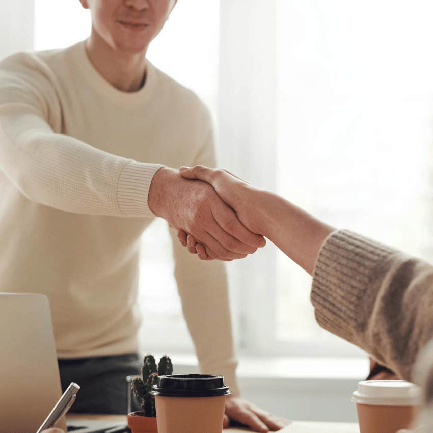 man and woman shaking hands for business