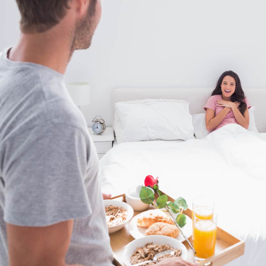 man bringing breakfast to woman in bed treating like a princess