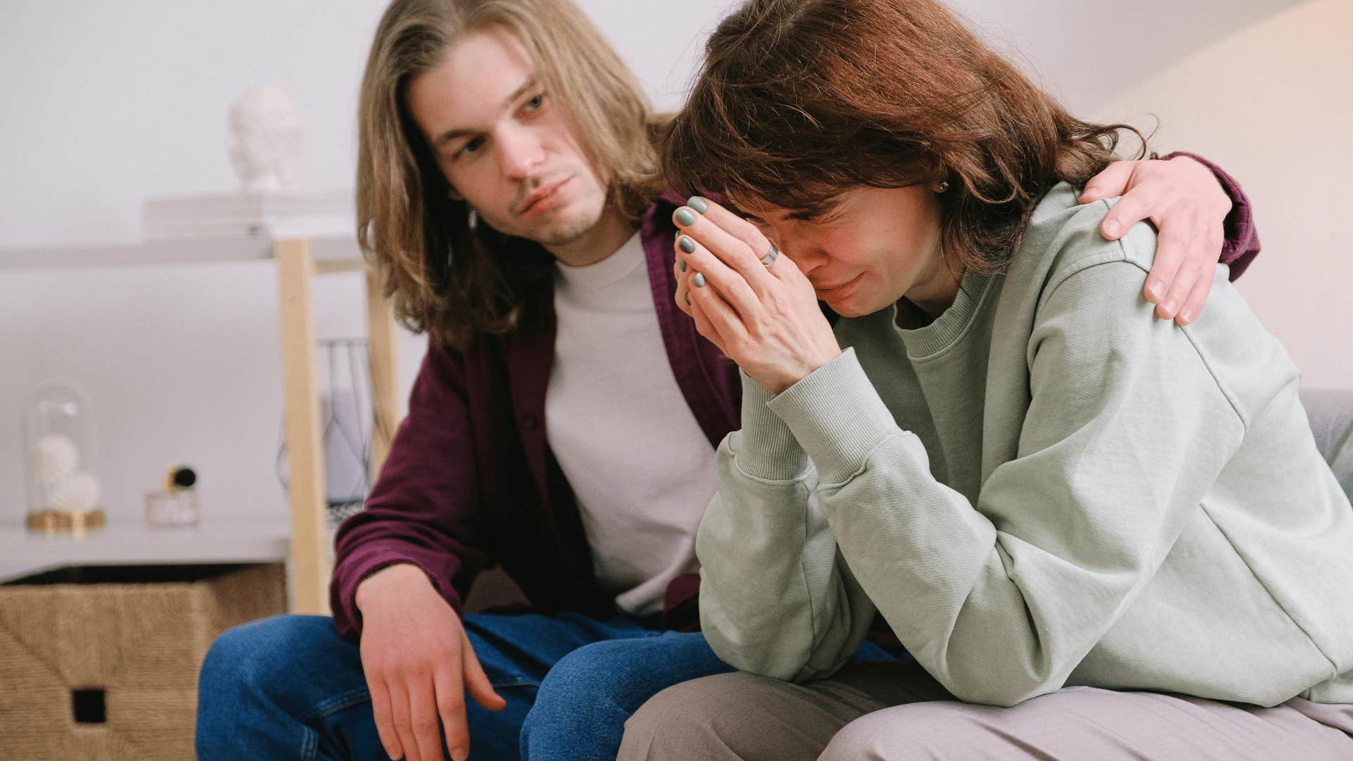 man comforting upset woman