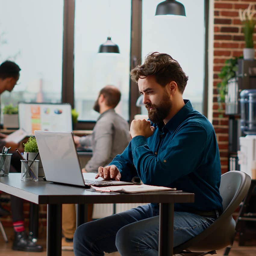 Man at his desk in an open office space