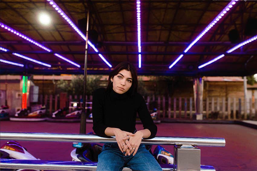 brunette woman with green eyes portrait in an amusement park