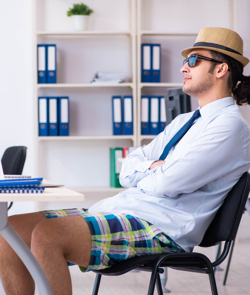 man wearing casual shorts a summer hat and sunglasses in an office