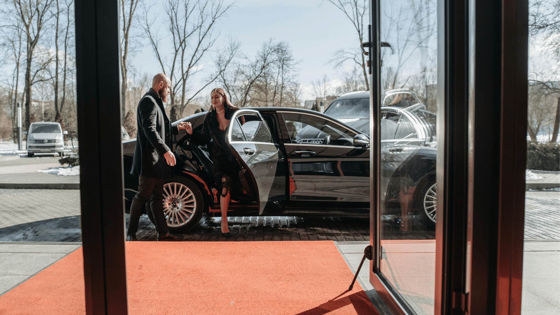 man helping woman out of car