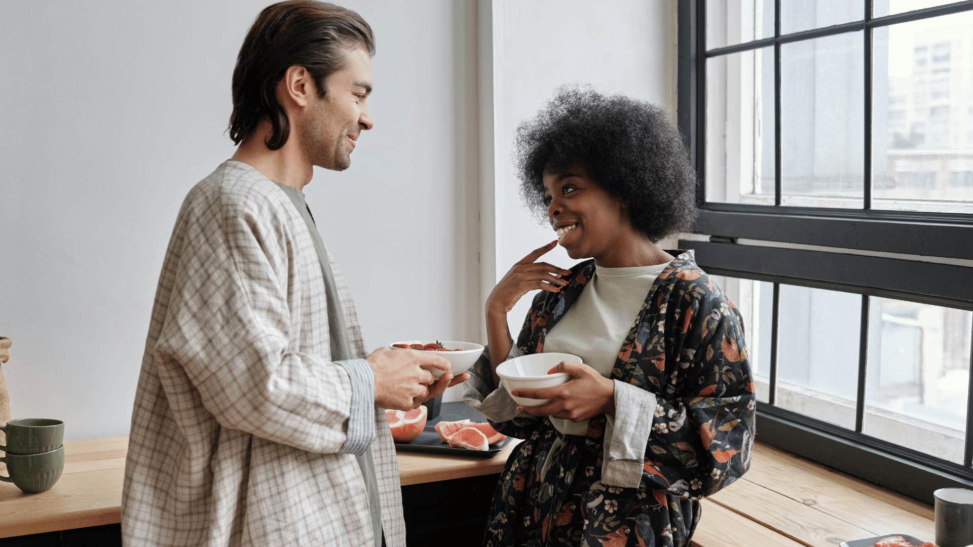 man smiling down at woman who is smiling back