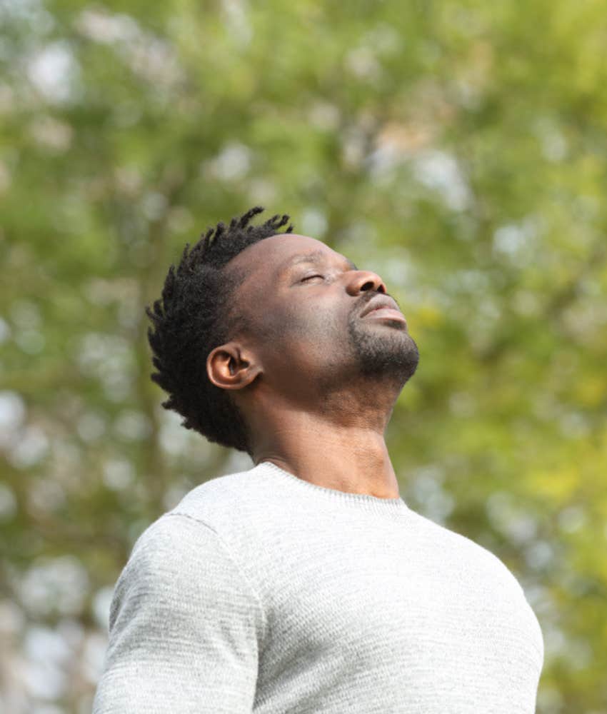 man with eyes closed taking a moment to connect with himself