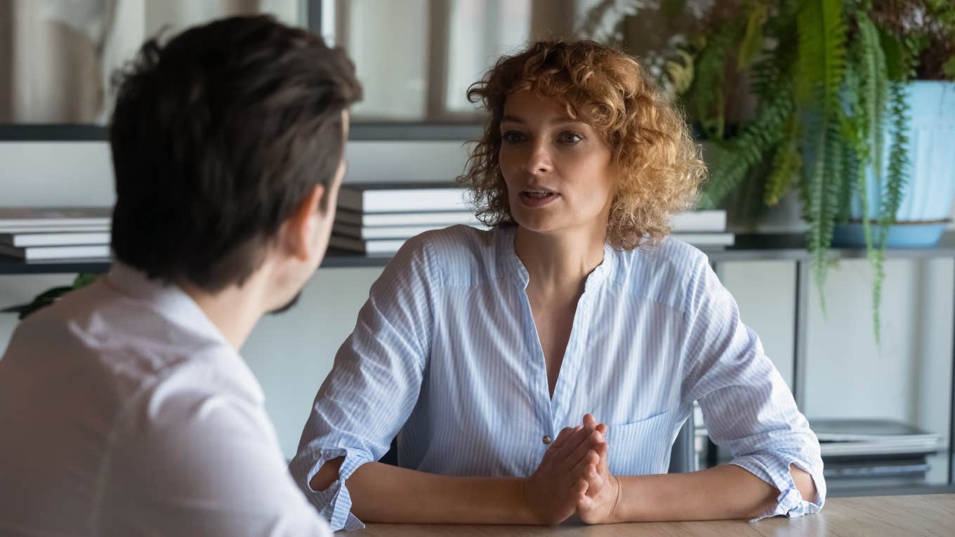 two businesspeople having conversation in office