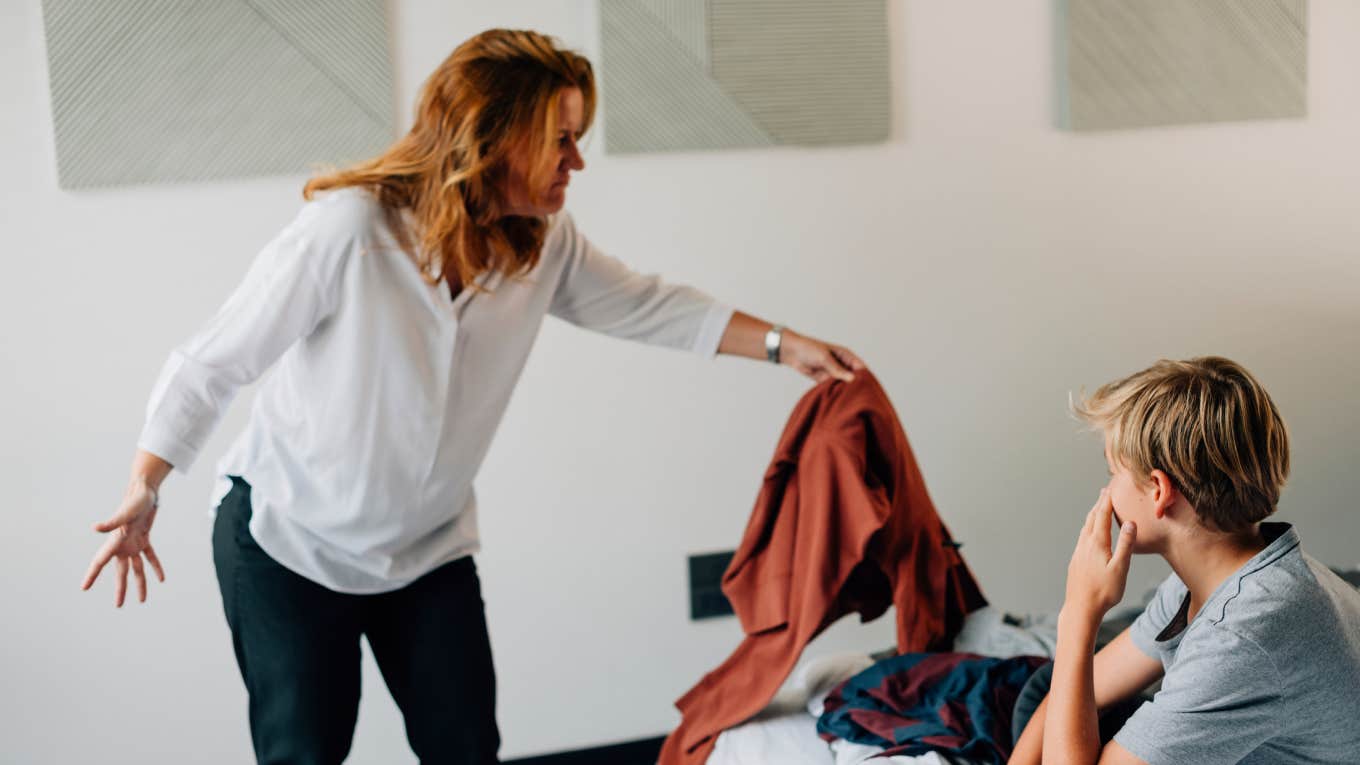 Mother scolding son for messy bedroom