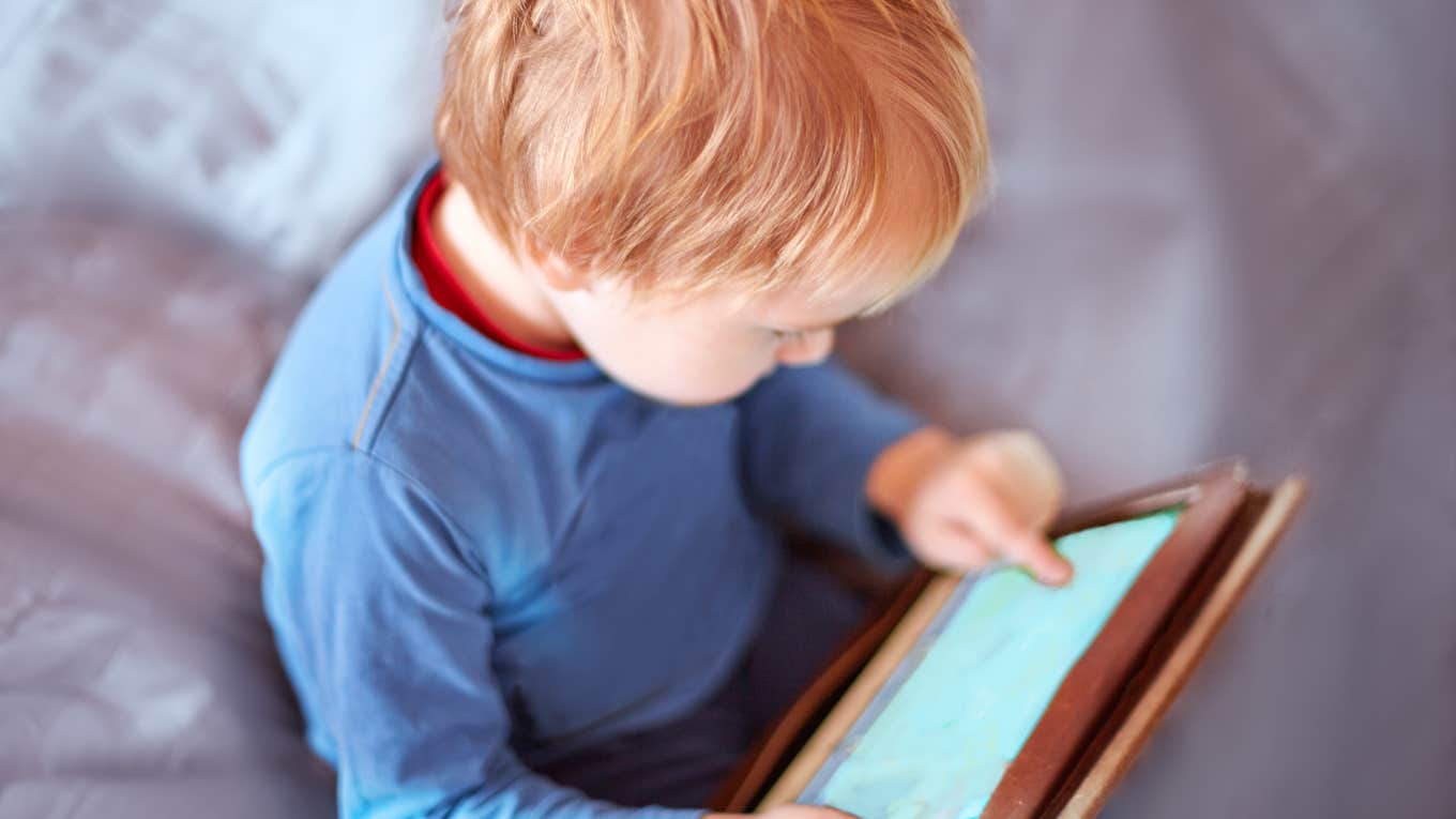 baby boy playing on tablet