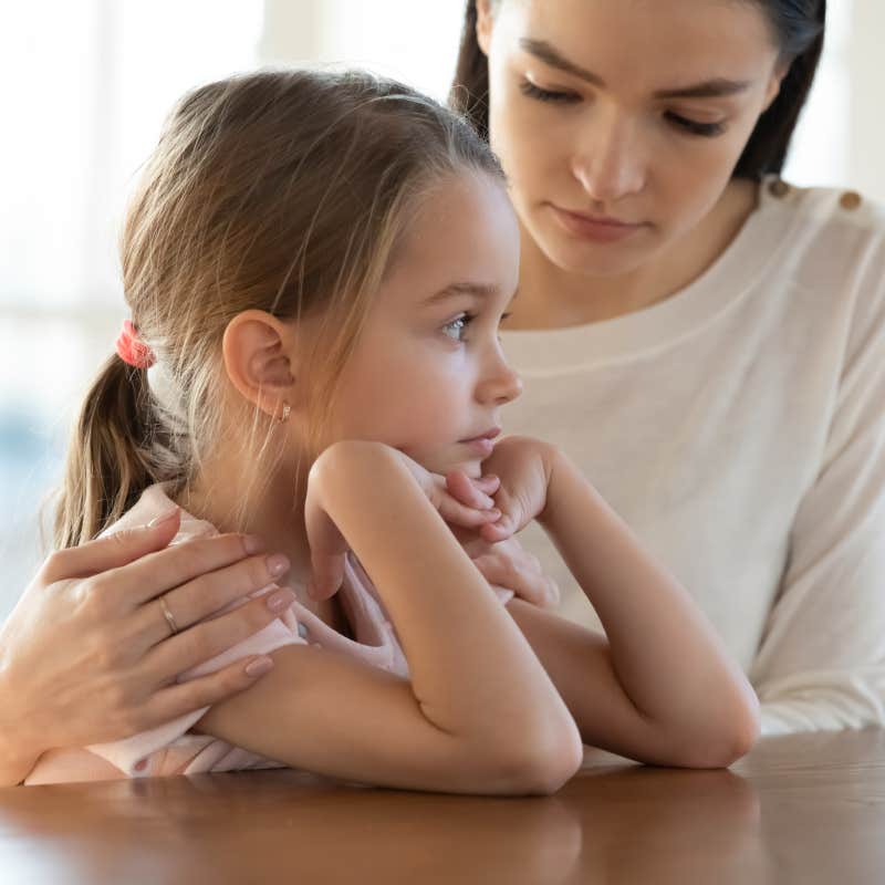 mom comforting upset daughter