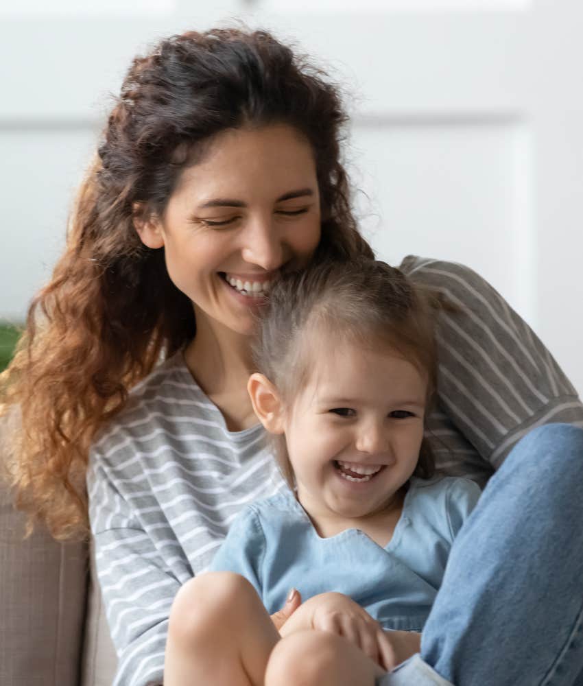 Mother hugging daughter with joy