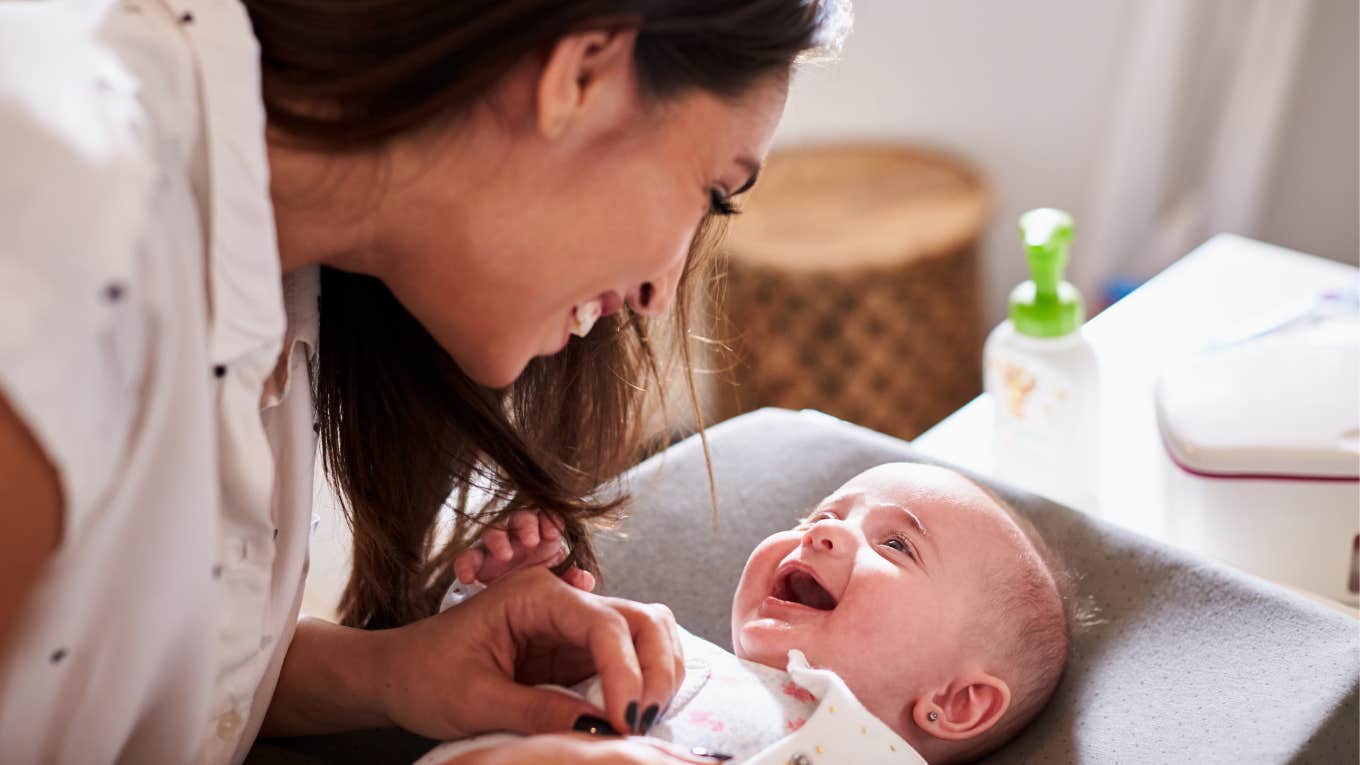 mom smiling at happy baby